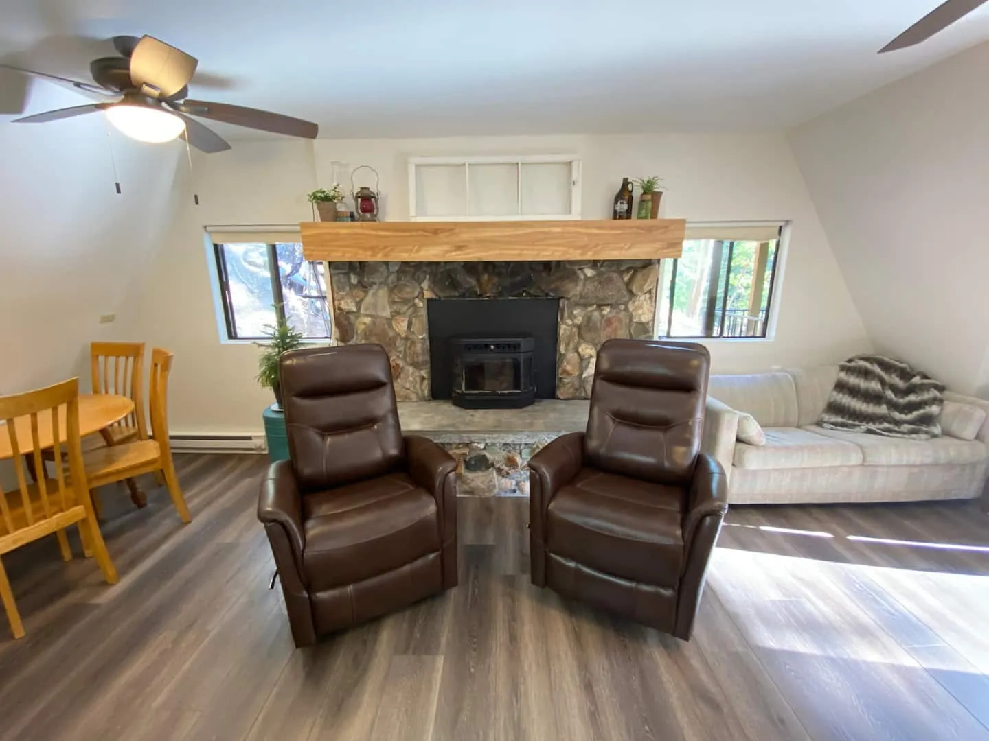 Great room with a stone fireplace and cozy recliners